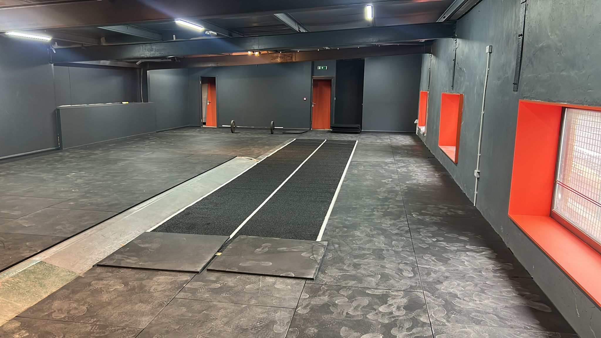 Finished gym floor with sled track laid through the middle